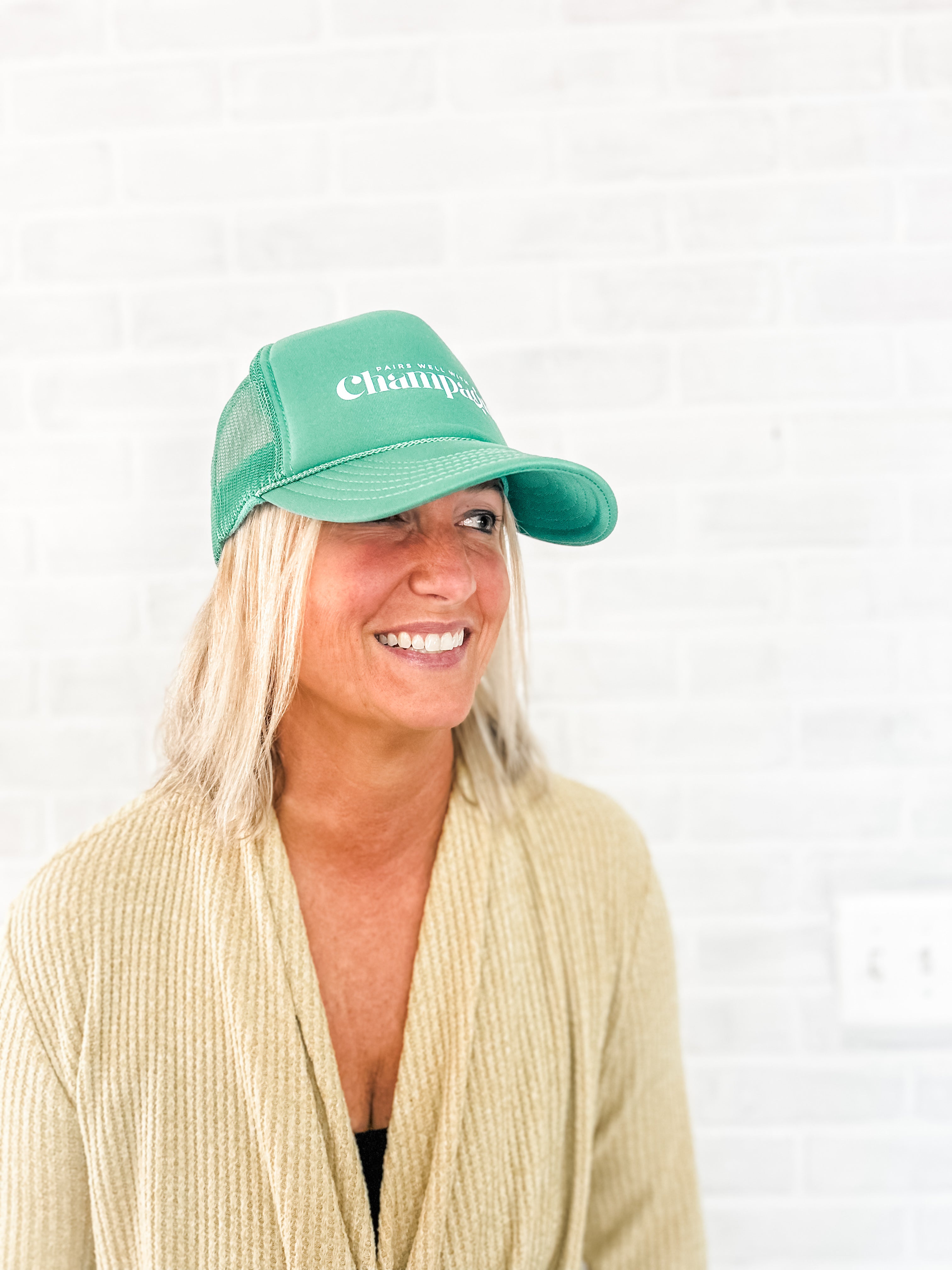 pairs well with champagne green foam corkie trucker hat